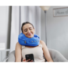 person texting while wearing comfortable neck supporting pillows for sleeping travel spine support - blue