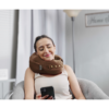person texting while wearing comfortable neck supporting pillows for sleeping travel spine support - brown