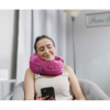 person texting while wearing comfortable neck supporting pillows for sleeping travel spine support - pink