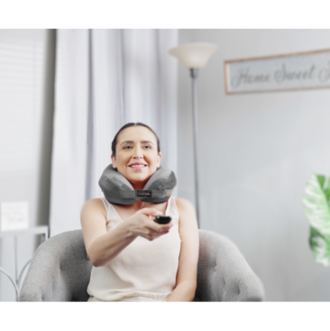 person wearing pillow for neck and back pain while watching TV - grey
