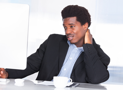 Portrait Of A Businessman Suffering From Neck Pain In Office
