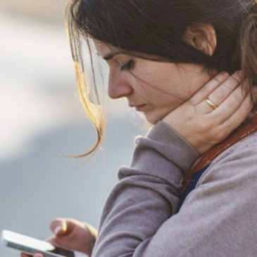 People looking down on phone causing forward head posture syndrome.