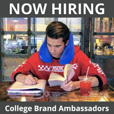College student studying in a cafe while his blue Neck Sofa pillow as a study pilllow.