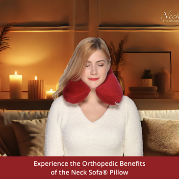 A image of a cozy, warmly lit room featuring a modern couch with a woman comfortably wearing a Burgundy Neck Sofa Pillow with her eyes closed