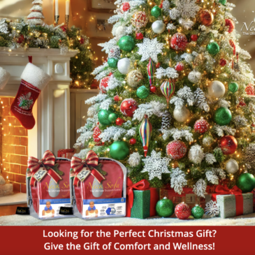 An image with a full view of the room, showcasing the vibrant Christmas tree along with a cozy and festive living space with a fireplace and Christmas gifts of two Burgundy Neck Sofa Pillows with ribbons on it in front of the Christmas tree.