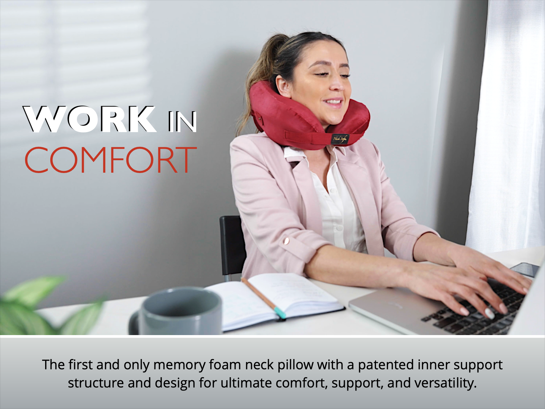 Woman using a burgundy Neck Sofa Pillow while working on her computer.