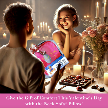 A scene with a man sitting at a table giving a Neck Sofa Pillow to his girlfriend as a Valentine’s Day gift with a ribbon on it. The room has a warm, intimate ambiance to it, bringing the romantic setting to life with the flowers and chocolates.